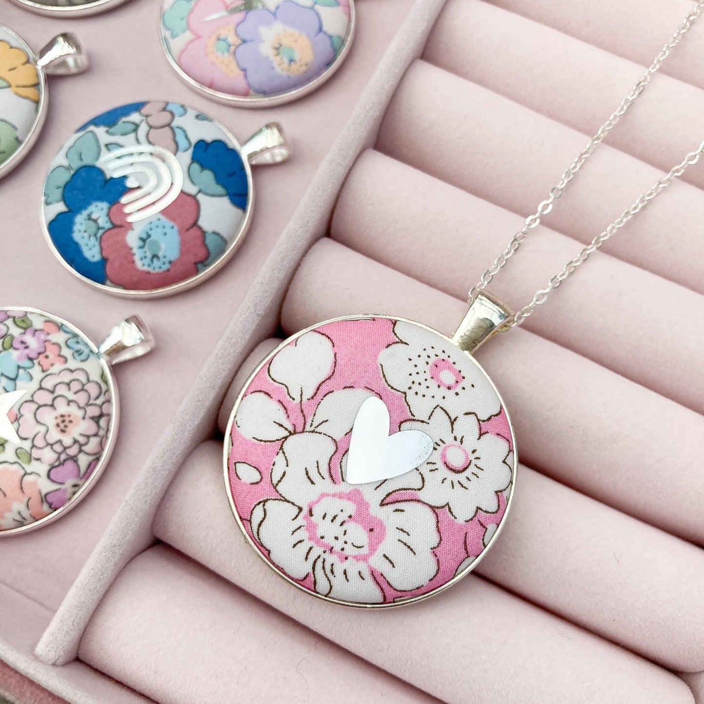 Pink floral fabric necklace with a silver heart in a pink jewellery box