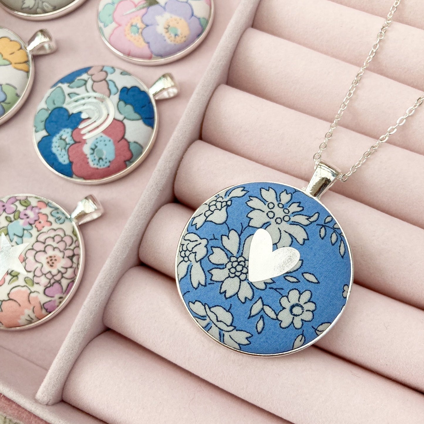 Blue Liberty floral necklace with a silver heart in a pink jewellery box