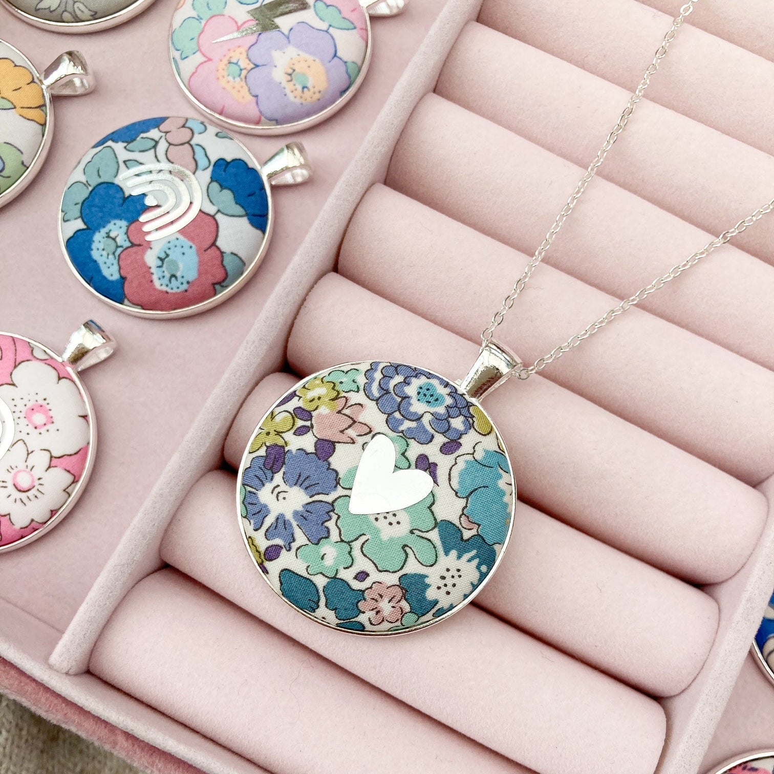 Teal & purple floral necklace with silver heart in a pink jewellery box
