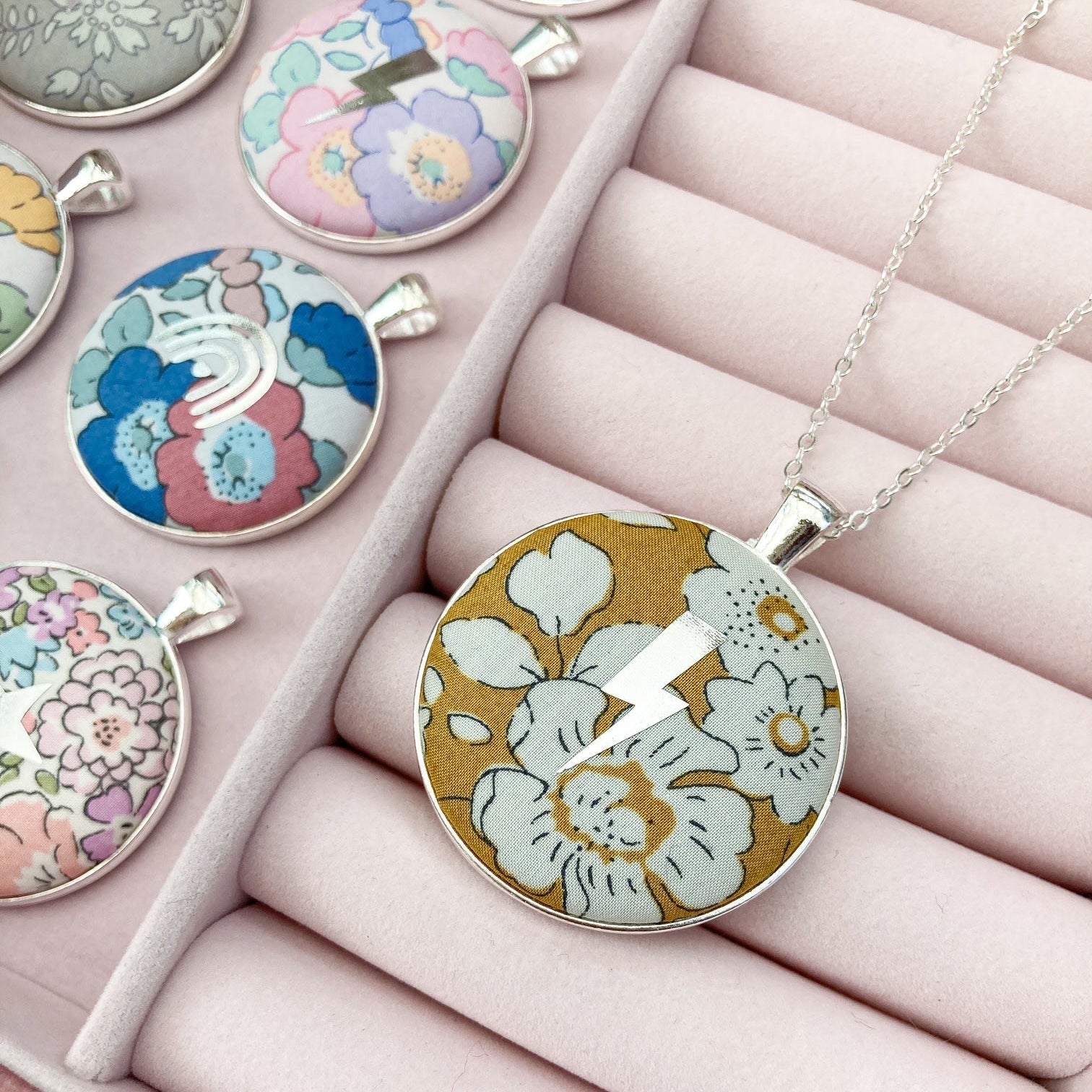 Lightning & floral pendant necklaces in a jewellery box
