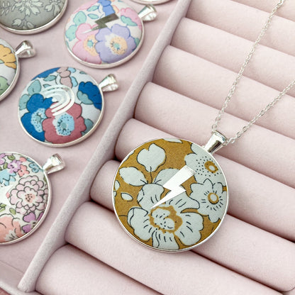 Lightning & floral pendant necklaces in a jewellery box