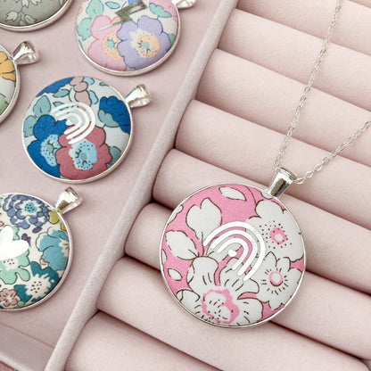 Floral patterned pendants on a pink jewelry box