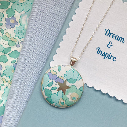 Aqua & lilac floral necklace with star design and a fabric message saying "Dream & Inspire"