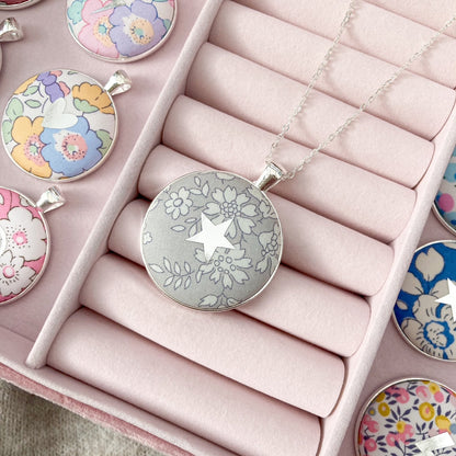 Grey Liberty fabric necklace with a star design in a pink jewellery box