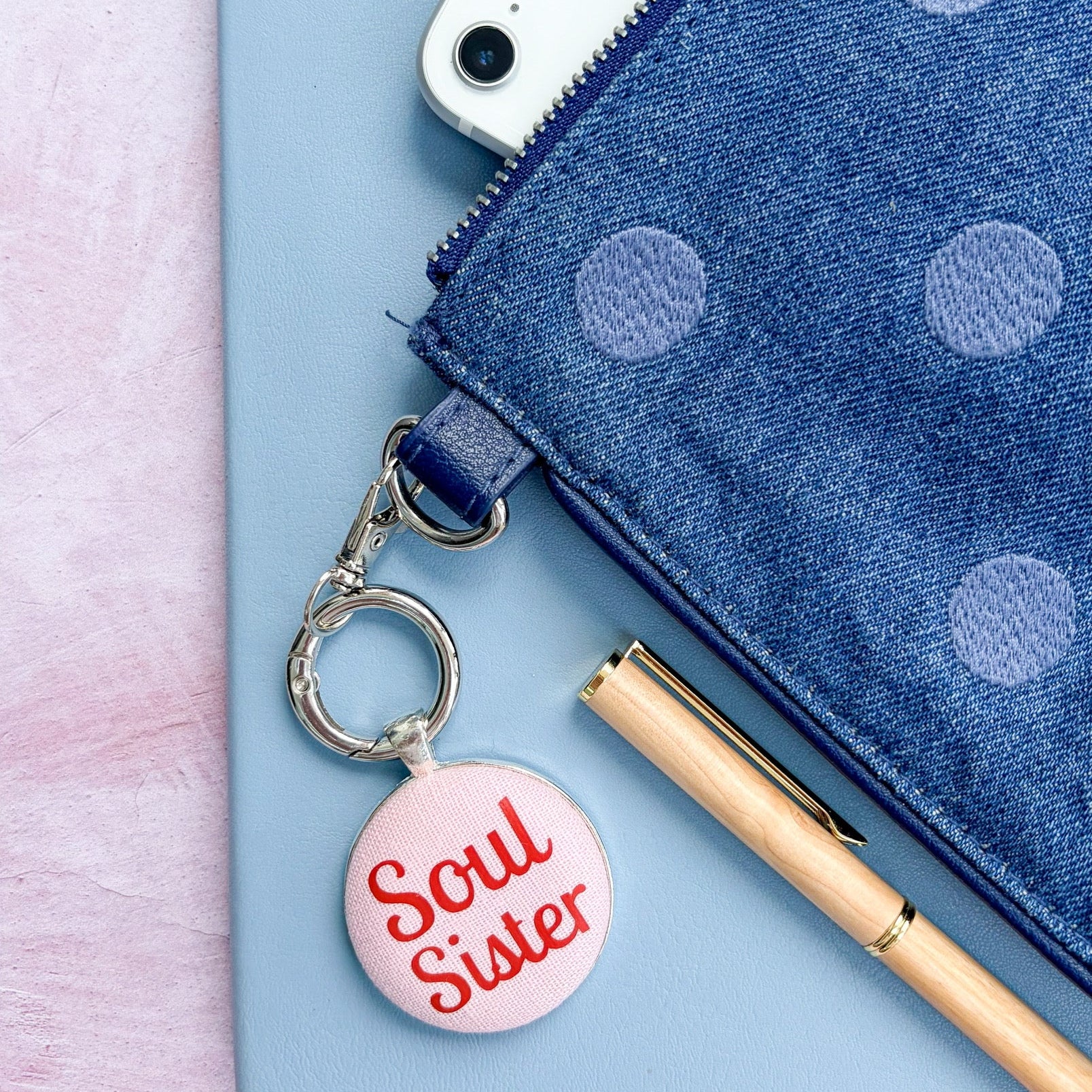 Keyring with 'Soul Sister' charm on a blue pouch with polka dots