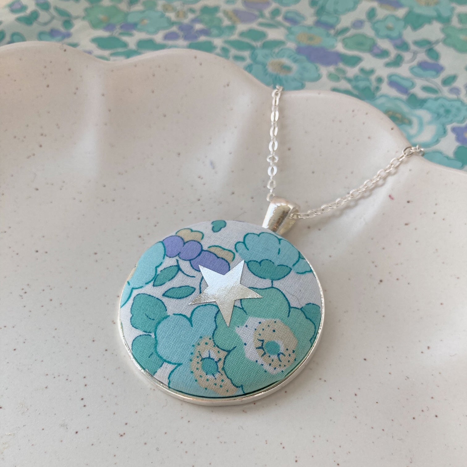 Star necklace made with aqua and lilac fabric