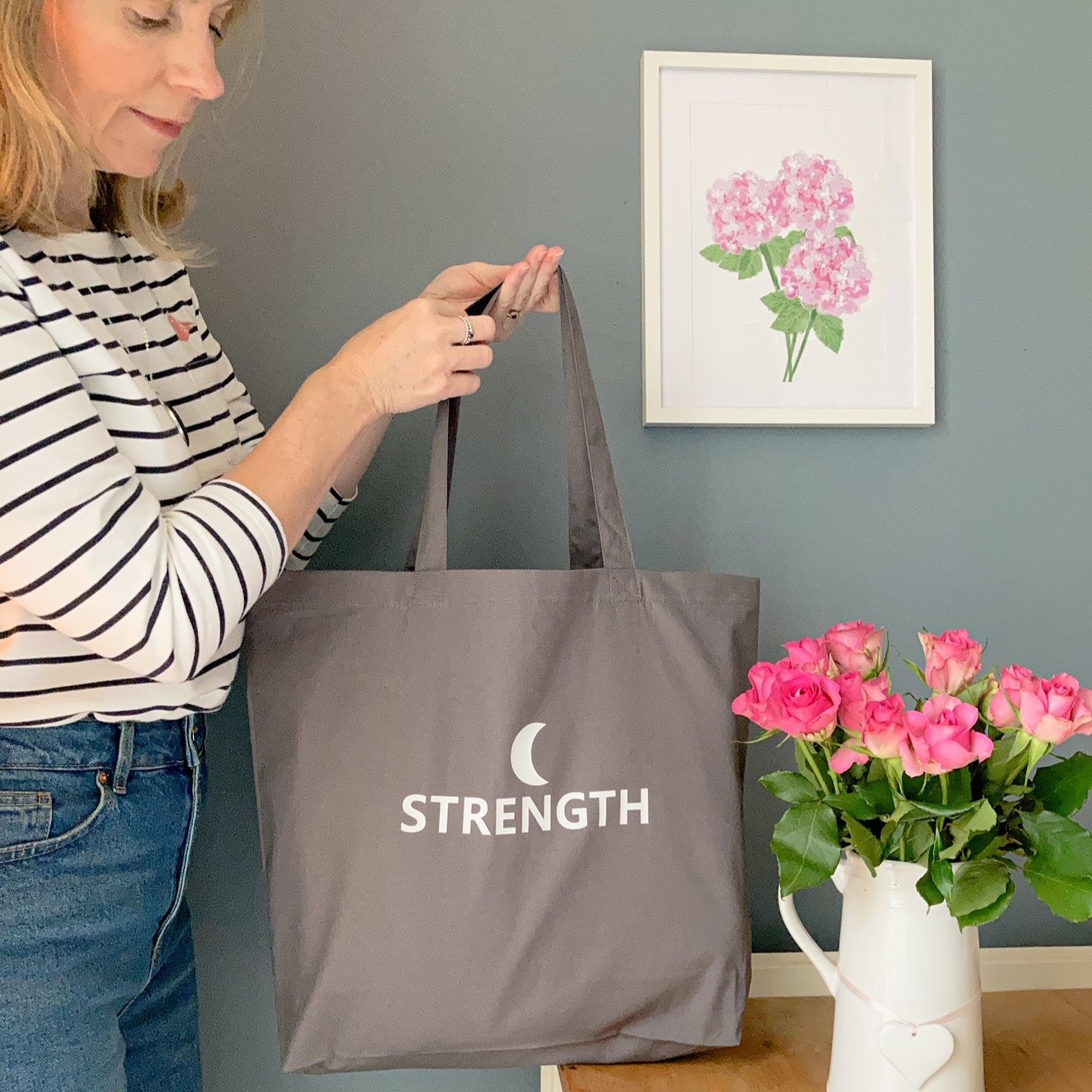 Large grey tote bag with the word strength printed