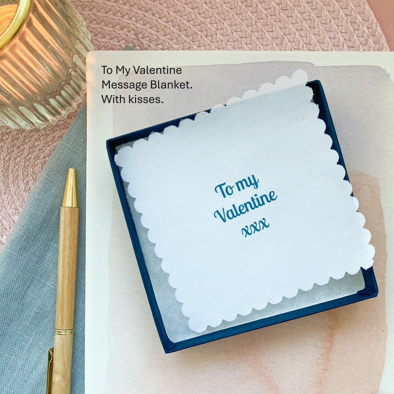 Valentine's Day message blanket with a pen on a textured surface