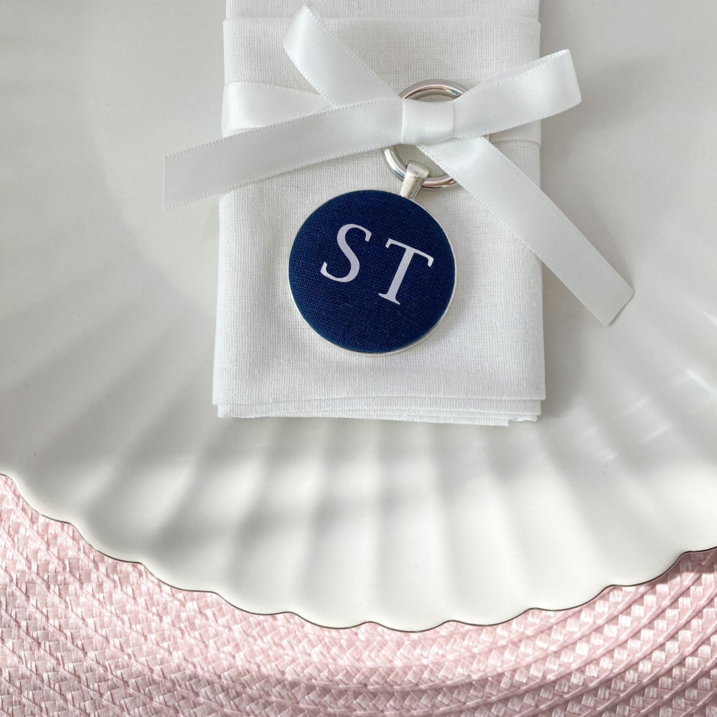 Wedding place setting and favour keyring in navy blue linen fabric personalised with initials