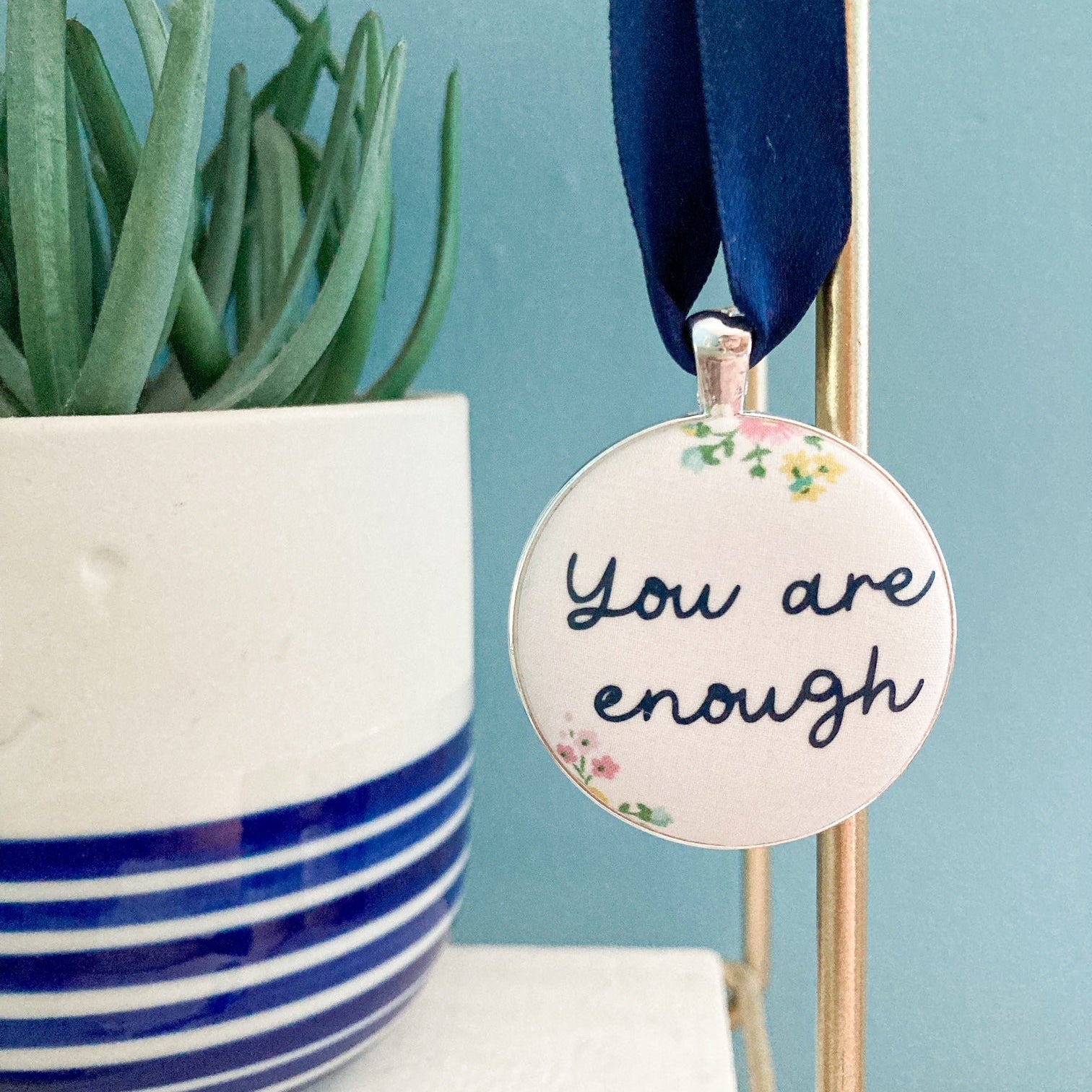 You Are Enough keepsake made with cream floral Liberty fabric on a blue ribbon