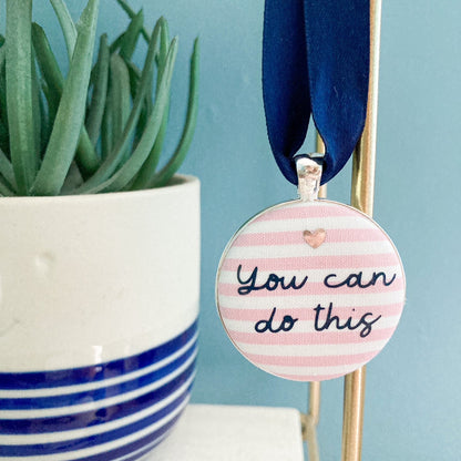 You Can Do This keepsake printed onto pink and white striped fabric with a navy blue ribbon