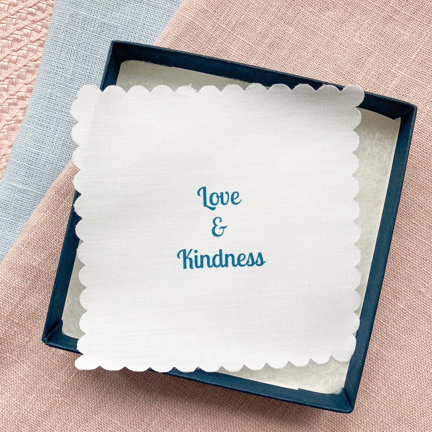 Gift box with a fabric message printed with 'Love & Kindness' text